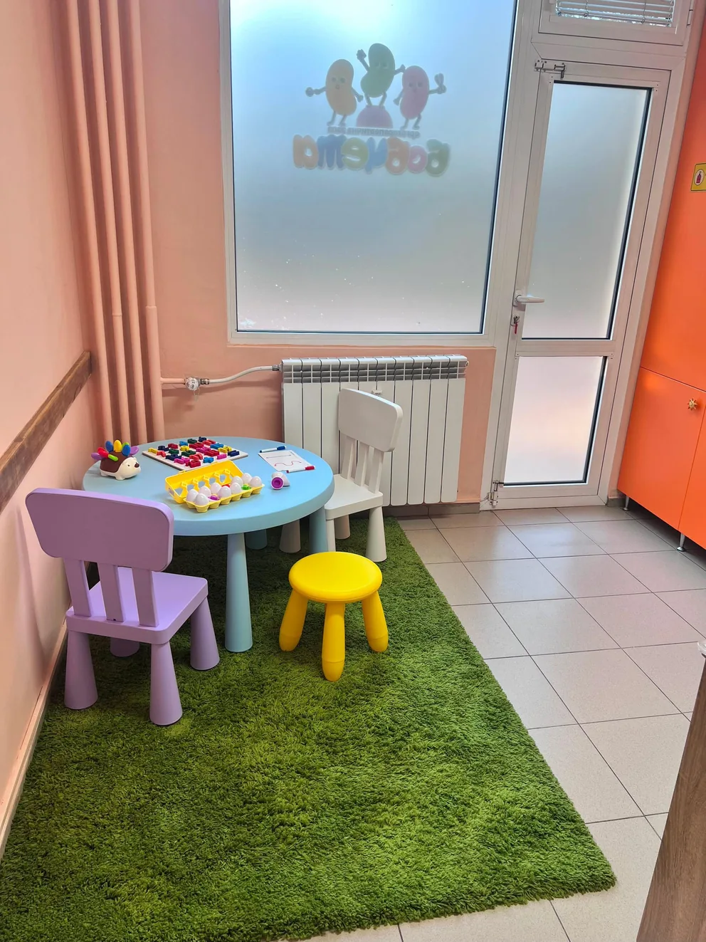 A colourful therapy play room with a children's table